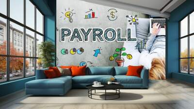 Payroll text with man using a laptop Wall mural