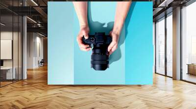 Person holding a SLR camera from above Wall mural