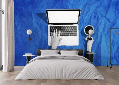 Person using a laptop computer - crumpled paper background Wall mural