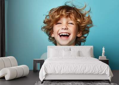 Portrait of a happy young boy on a solid background Wall mural