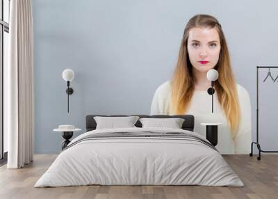 portrait of a young woman on a gray background Wall mural