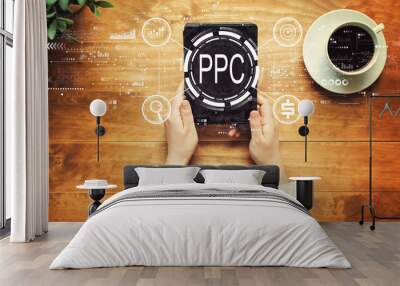 PPC - Pay per click concept with a person holding a tablet computer Wall mural