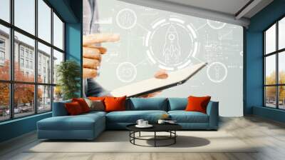 Rapid growth concept with young man holding a tablet computer Wall mural