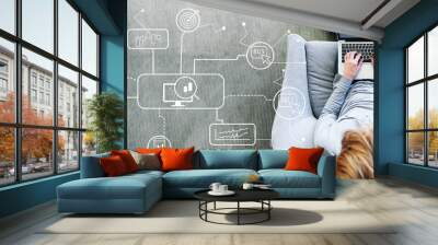 Stock trading theme with man using a laptop in a modern gray chair Wall mural