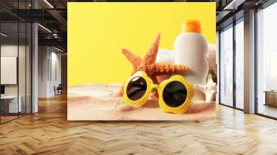 Sunblock Bottle with summer accessories on solid background Wall mural