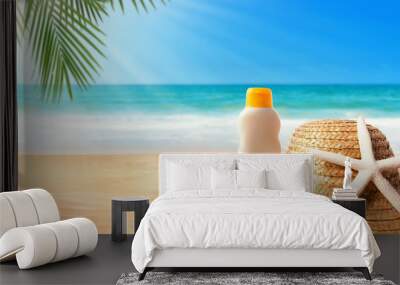 Sunblock with straw hat on the tropical beach and sunshine Wall mural