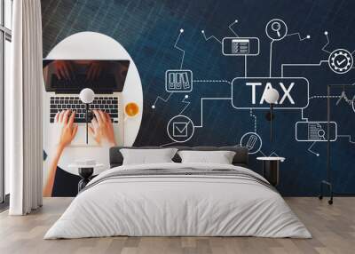 Tax theme with person using a laptop on a white table Wall mural