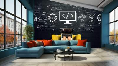 Web development concept with person using a laptop in a chair Wall mural