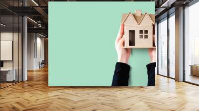 Woman holding a cardboard house overhead view Wall mural