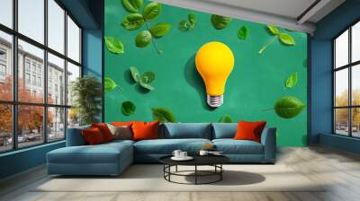 Yellow light bulb with green leaves Wall mural