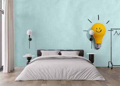 Yellow light bulb with happy face - flat lay Wall mural