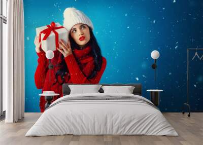 Young woman holding a Christmas gift box Wall mural