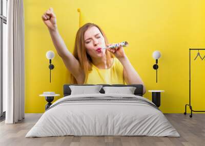 Young woman with party theme on a yellow background Wall mural