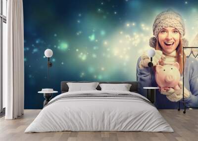 Young woman with pink piggy bank Wall mural