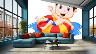 Boy floating on an inflatable circle in the pool Wall mural