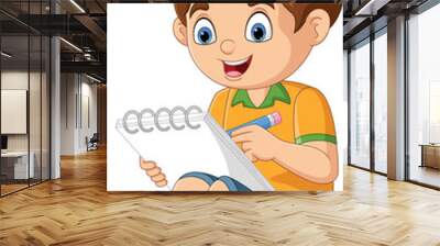 Cartoon little boy sitting and writing on notebook Wall mural