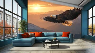 A majestic bald eagle soaring high above the mountains at sunset, with its wings spread wide and eyes focused on searching for prey Wall mural