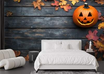 Pumpkins and fallen leaves on wooden background. Wall mural