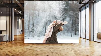 Beautiful young woman enjoying in the snow Wall mural