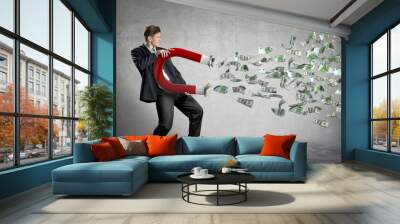 businessman attracts money with a large magnet Wall mural