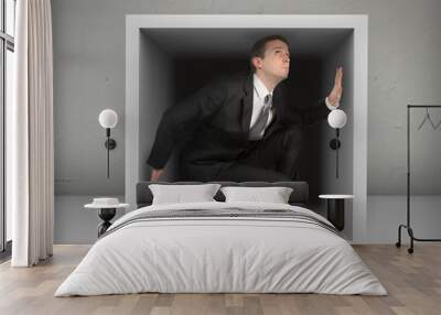 Businessman in a box,gray background Wall mural