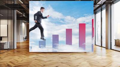 Businessman jumping on a growth graphic Wall mural