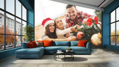 family decorating a christmas tree Wall mural