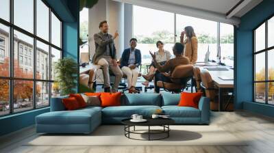 Group of Smiling Businesspeople in a Casual Meeting at their Company.

Team of five multi-ethnic employee having fun working together in an open plan office with big windows. Wall mural