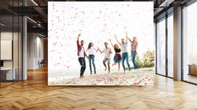 group of young people celebrating at the beach Wall mural