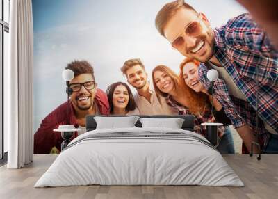 Group of young people having fun outdoors on the beach  Wall mural