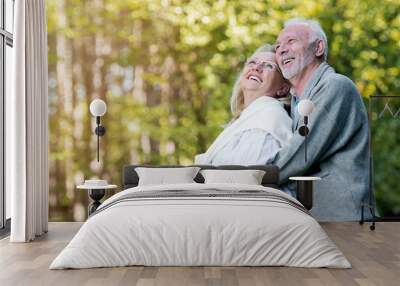 Happy elderly couple smiling outdoors in nature  Wall mural