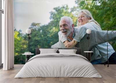 Happy senior couple smiling outdoors in nature  Wall mural