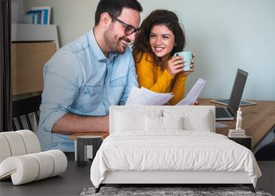 Smiling couple manage finances at home stock photo Wall mural