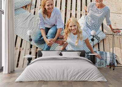 Three women enjoying outdoors, talking and laughing  Wall mural