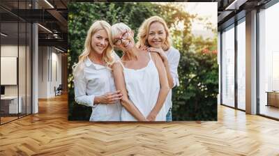 Three women enjoying outdoors, talking and laughing  Wall mural