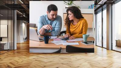 Worried husband and wife manage finances at home stock photo Wall mural