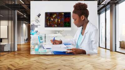 african-american biologist checks records in scientific lab or research facility Wall mural