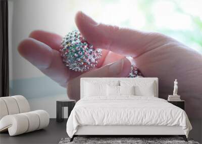 Silver metal magnetic balls, spiky tool for hand massage. Therapy Tool for Pressure Relief and relaxation of sore muscles. Two balls in middle aged female hand. Wall mural