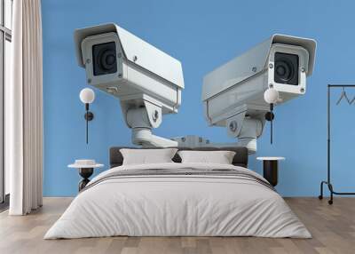 Two Outdoor Security Cameras on Mounting Pole Against Clear Blue Sky. Wall mural