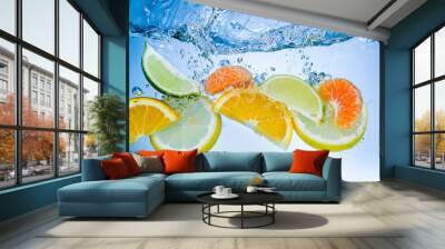 Tropical fruits fall deeply under water with a big splash Wall mural