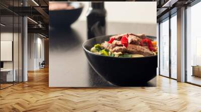 A bowl of homemade ramen topped with slices of steak and fresh red chilli Wall mural