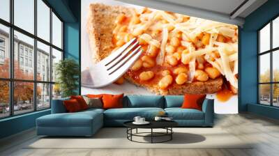 Close-up of baked beans on toast topped with grated cheese Wall mural