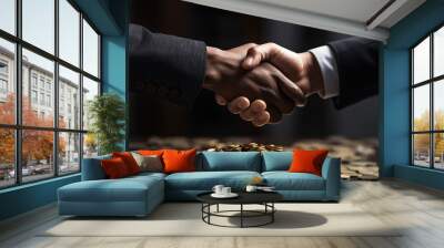 Handshake between two businessman with gold coins in the background Wall mural