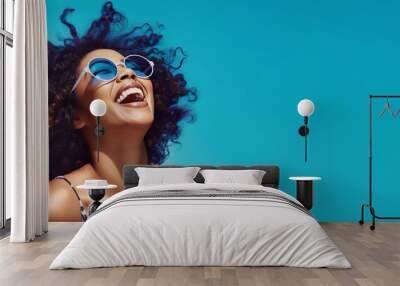 Happy black woman in straw hat and sunglasses on bright blue background. Woman isolated face portrait, banner with copy space background. Wall mural