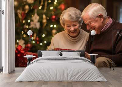 Joyful Senior Couple Unwrapping Christmas Gifts in Festive Roo Wall mural