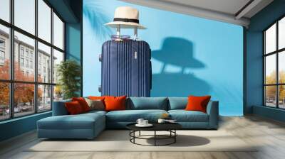 A suitcase is placed on a blue background Wall mural