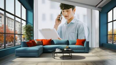 Asian businessman is calling to discuss about the work by the window Wall mural