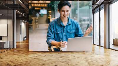 Asian man working at cafe on weekend Wall mural