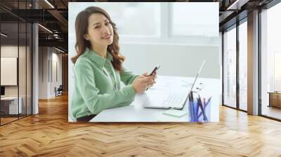 Beautiful Asian businesswoman sitting working at office Wall mural