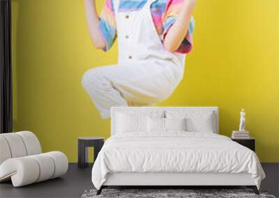 Full length image of Asian child posing on yellow background Wall mural